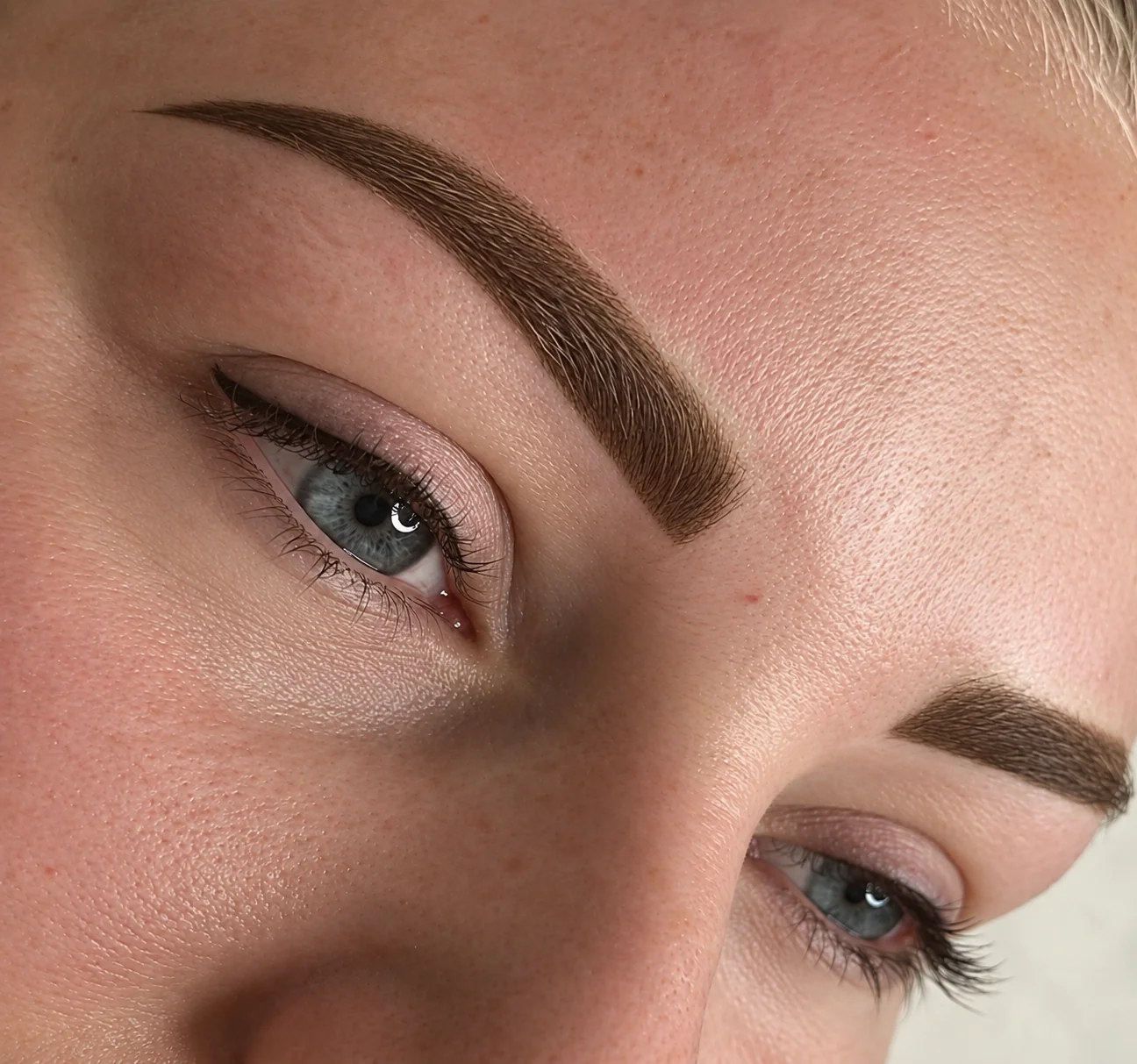 Softly defined permanent makeup brows in close-up
