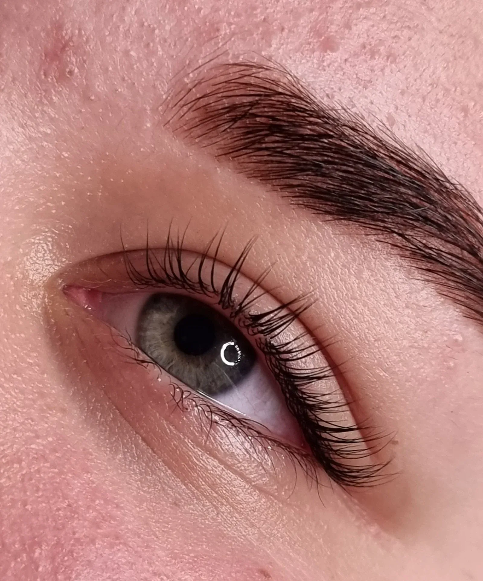Lash lift paired with a tinted, defined brow in a deep brown