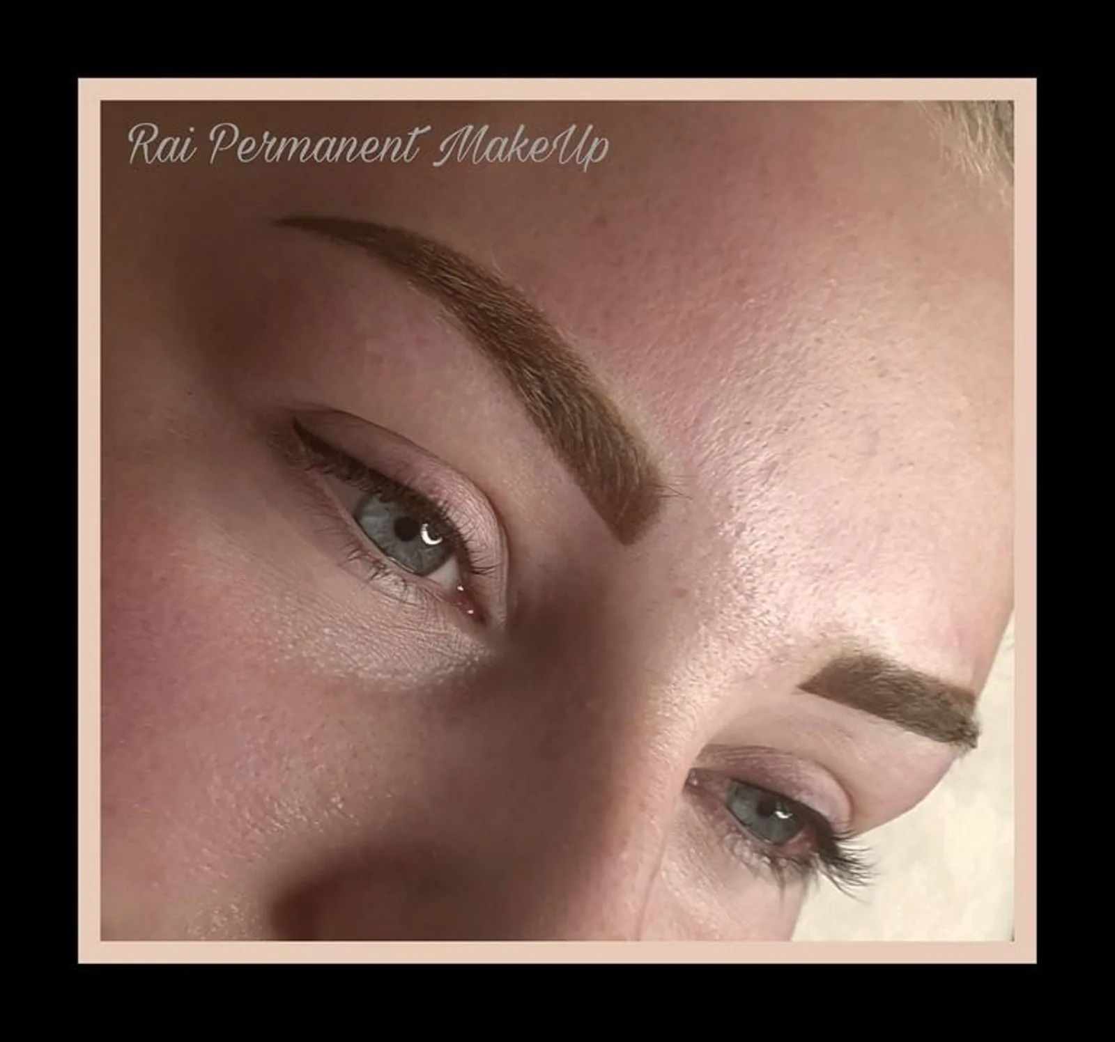 Ombre powder brows in a soft warm brown with a natural arch, shown in close-up