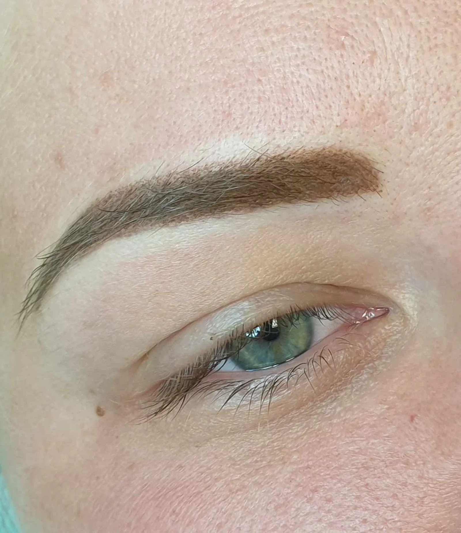 Soft powder brow with a natural finish, brushed through the client's own hair